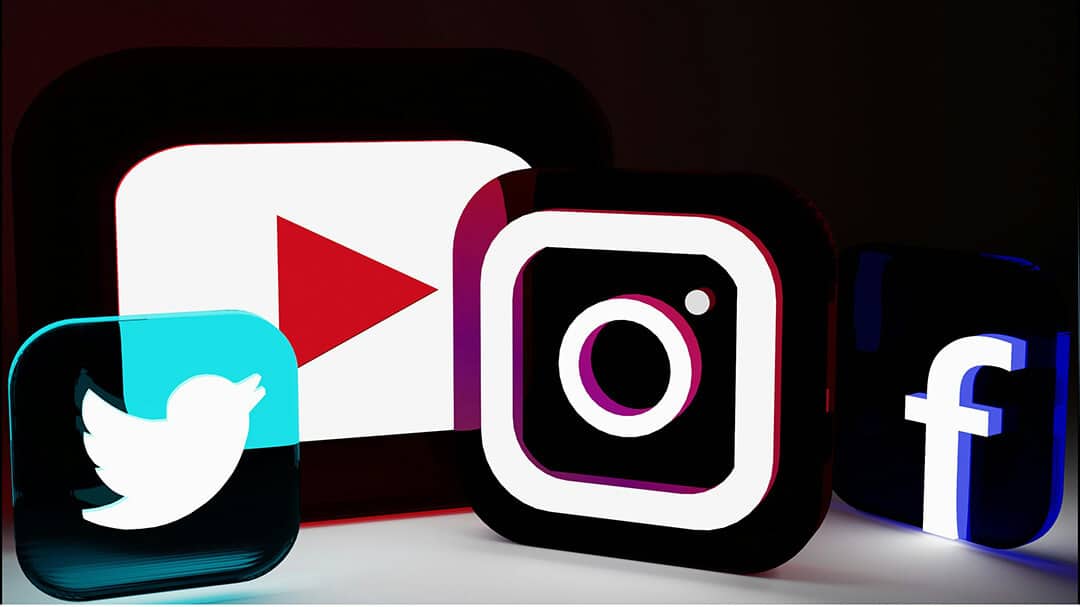 Neon signs for different social media platforms, Twitter/X, YouTube, Instagram, Facebook